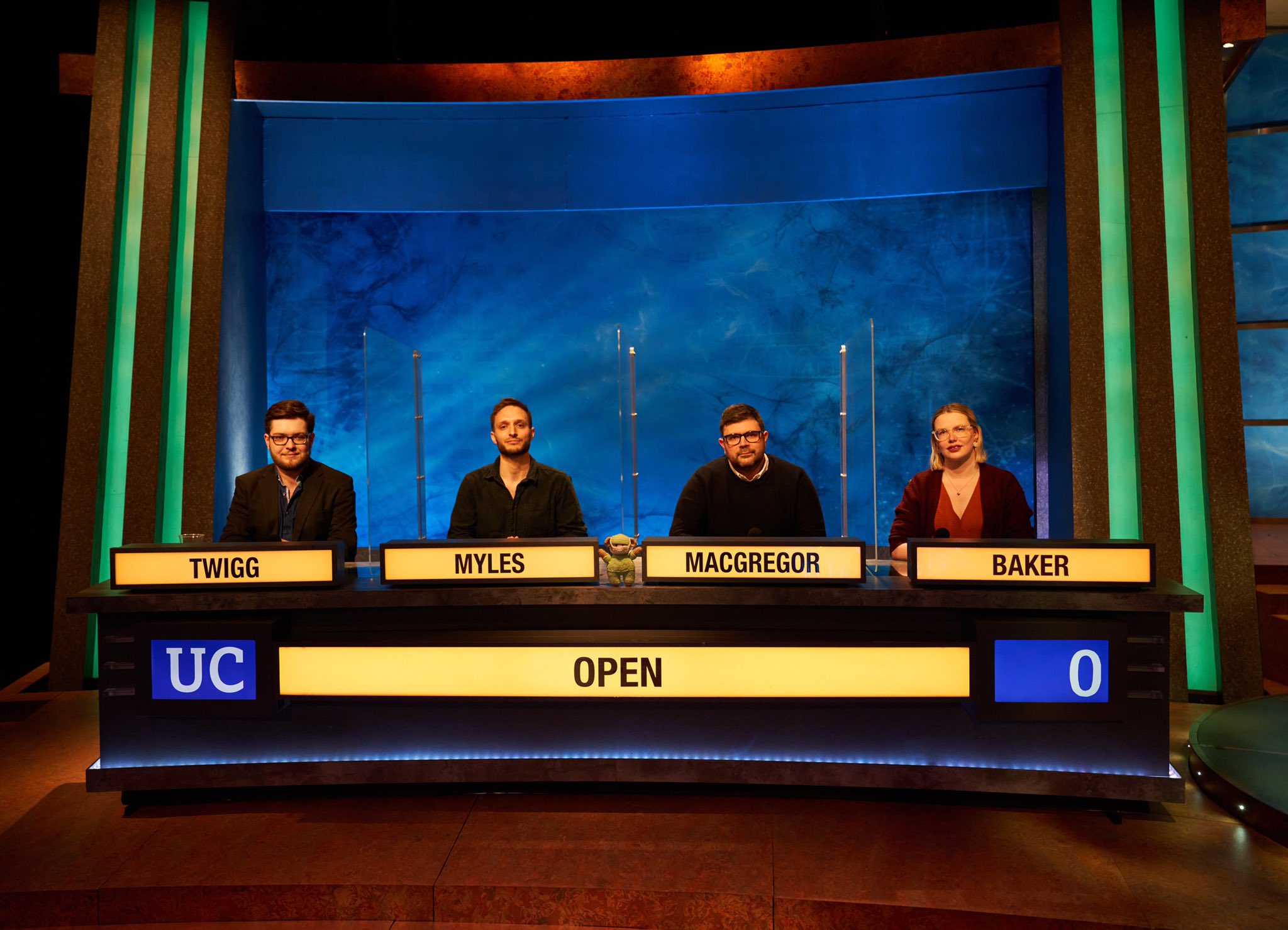 A photograph of the University Challenge team in the studio, from left to right Twigg, Myles, MacGregor, Baker.