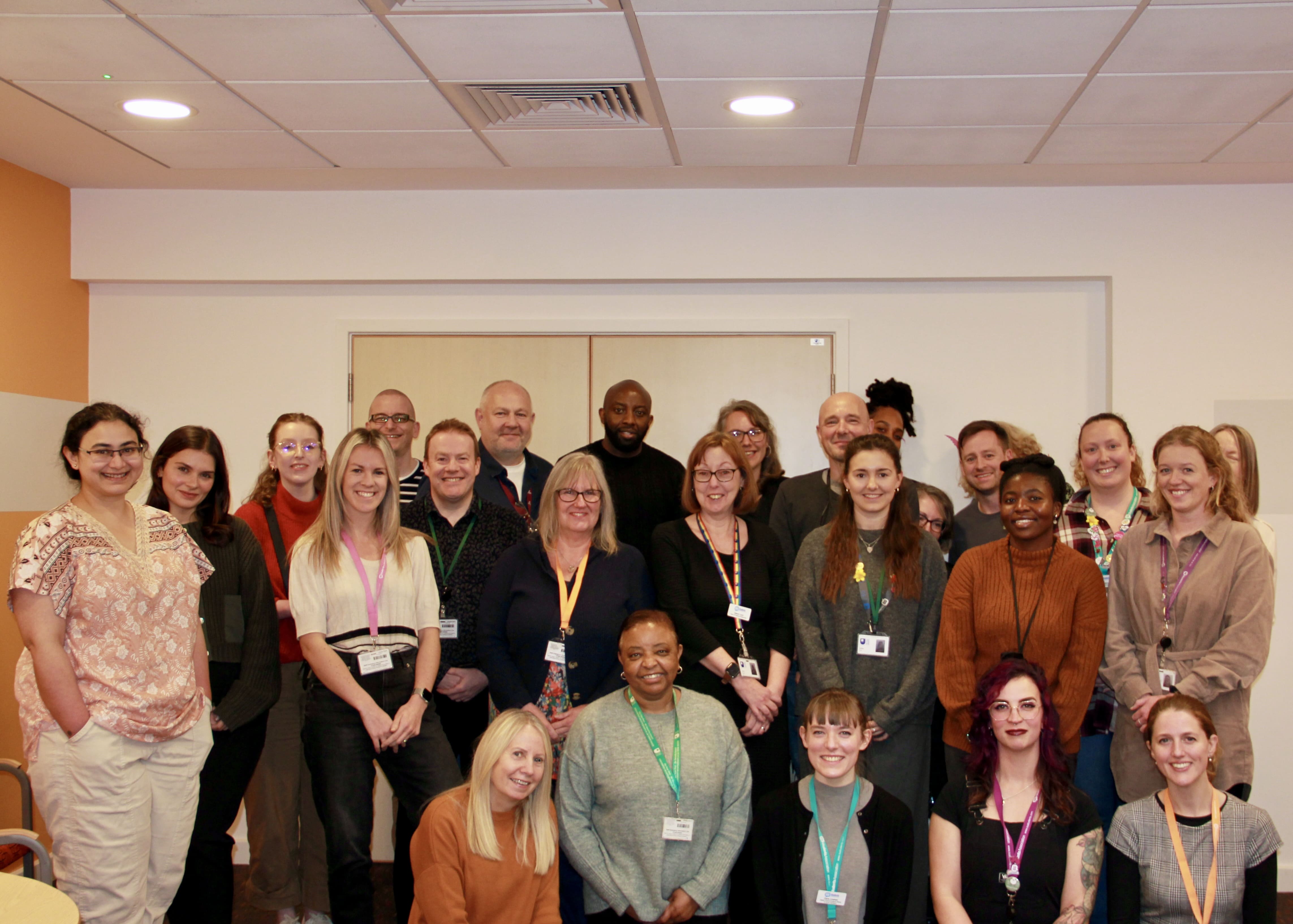 The staff team all smiling and posing for a photo.