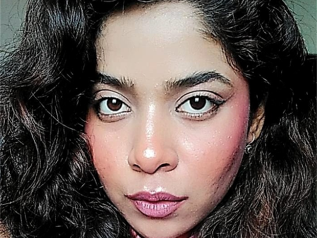A portrait photo of Sristi, wearing a pink top.