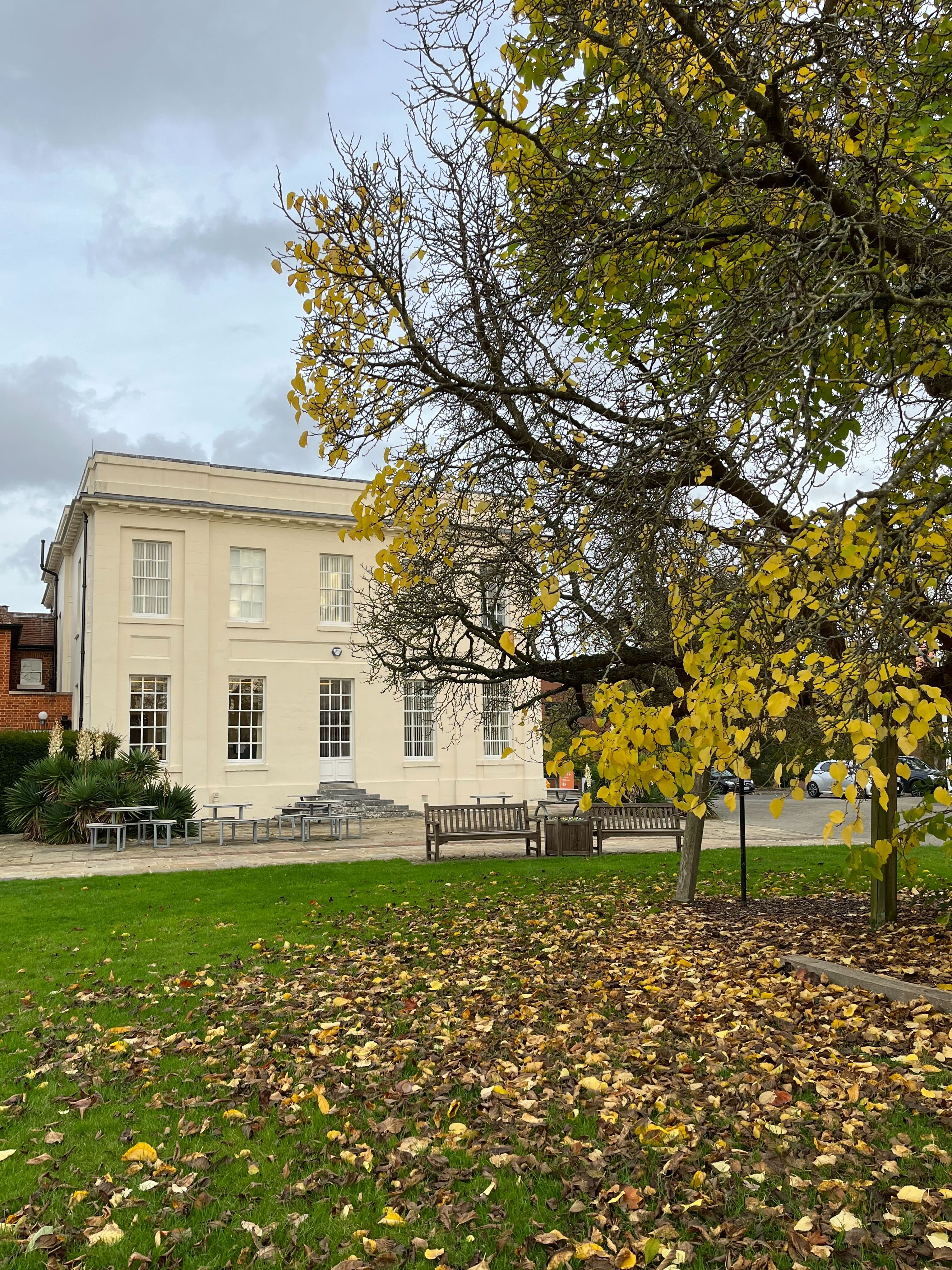 Walton Hall with autumn leaves in front of it.