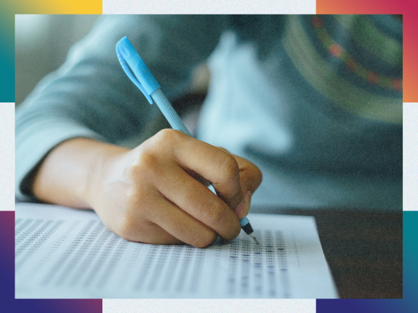 Someone filling in an exam paper.