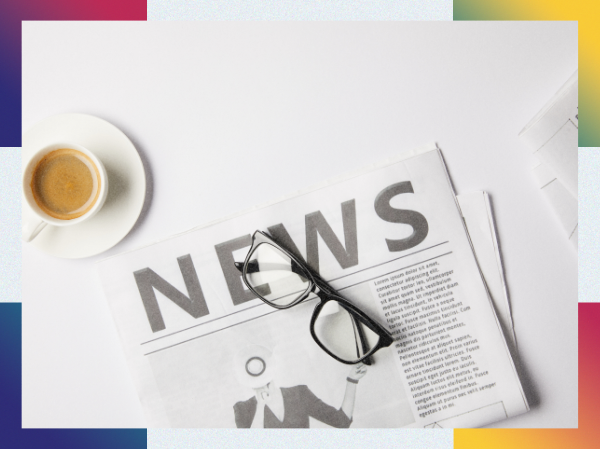 A newspaper with 'News' as the headline, along with a cup of tea and a pair of glasses.