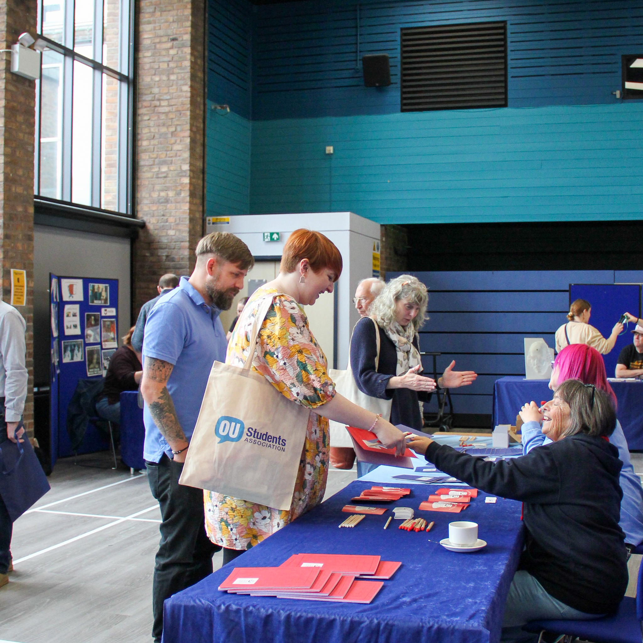 Image shows students speaking to volunteers at a stand